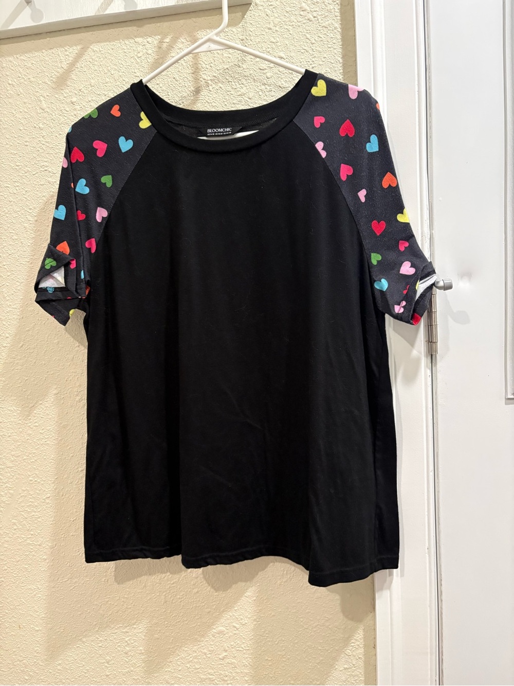 BloomChic Black Tee with Multicolor Heart Raglan Sleeves
